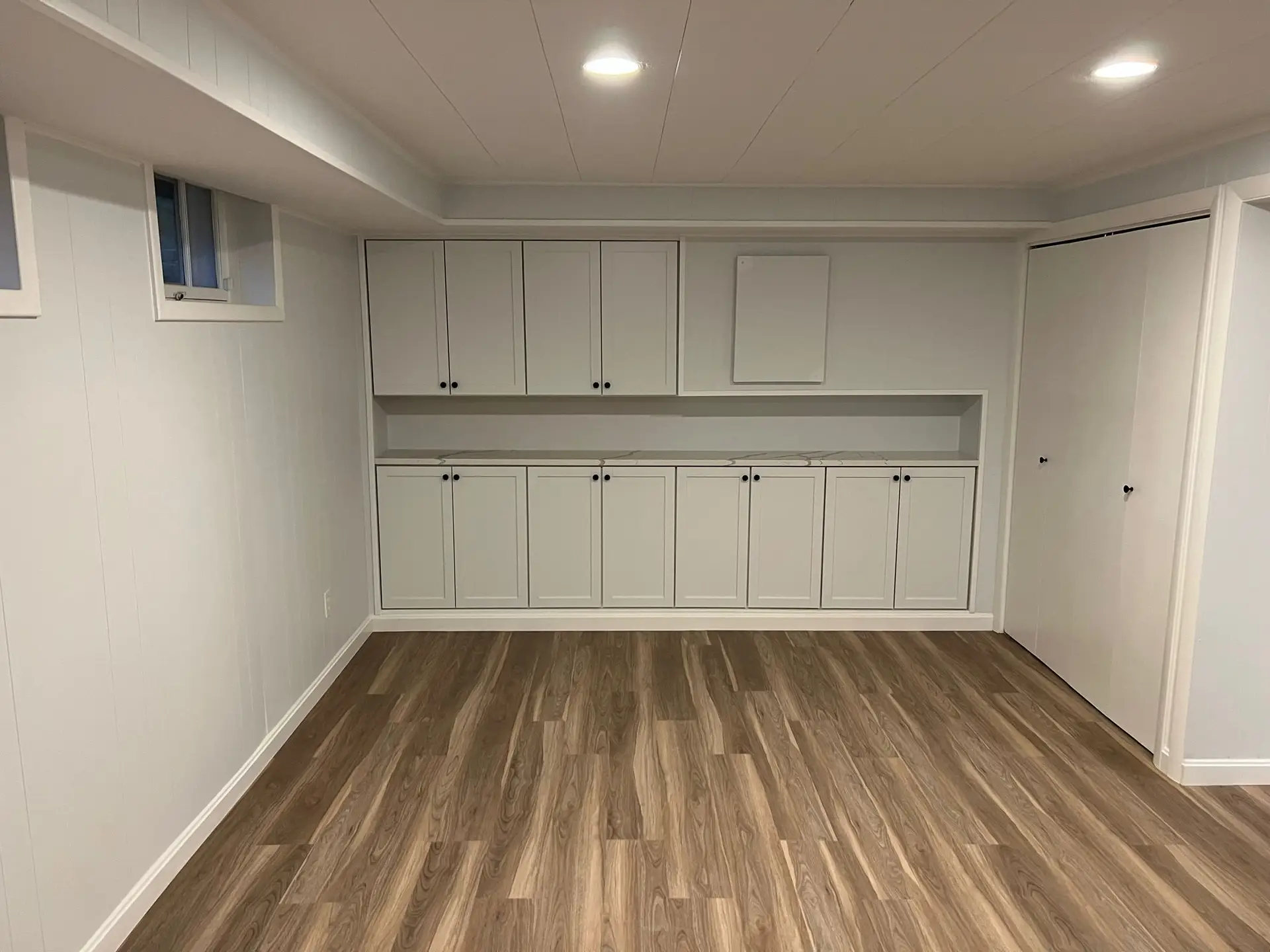 Freshly painted built-in cabinetry and finished basement walls