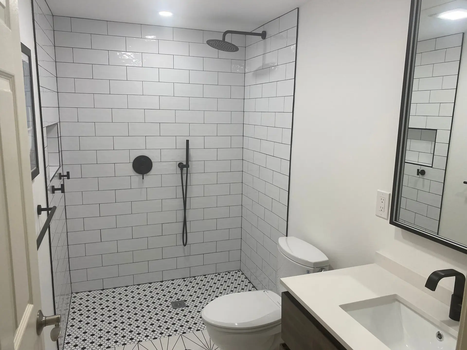 Bathroom remodel with subway tile shower and black fixtures
